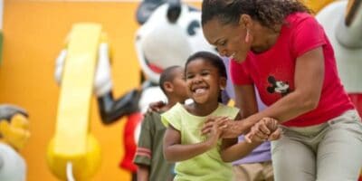 mother and her child in front of mickey statue at pop century resort in disney world