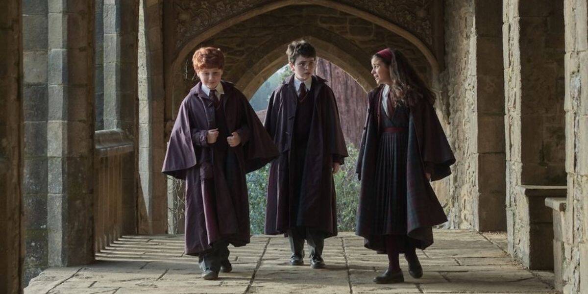 Ron, Harry, and Hermione walking through the halls of Hogwarts