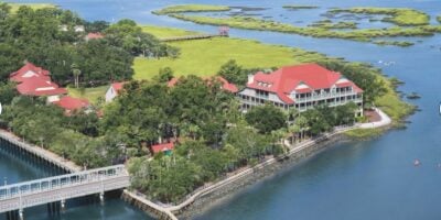 disney resort by the water and green trees