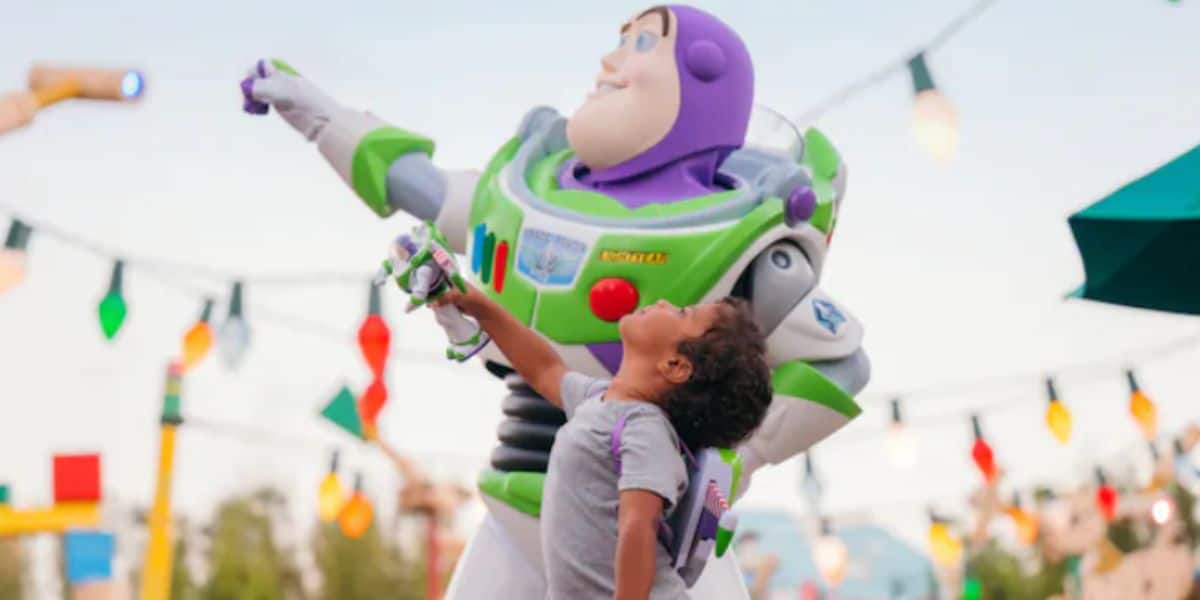 a young guest poses with Buzz Lightyear in Toy Story Land in Disney's Hollywood Studios park