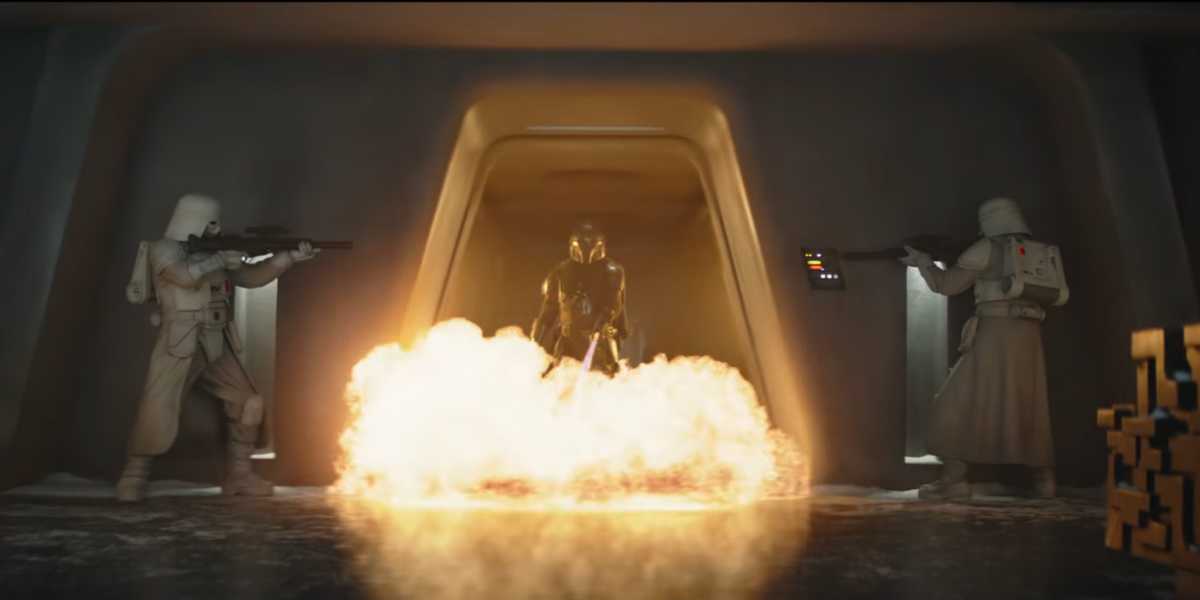 Din Djarin using a flamethrower on two snowtroopers in 'The Mandalorian and Grogu'