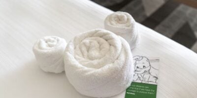 "Mousekeeping" crew leaves towels on hotel bed in the shape of Mickey Mouse