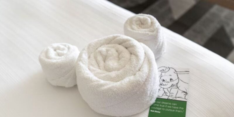 "Mousekeeping" crew leaves towels on hotel bed in the shape of Mickey Mouse