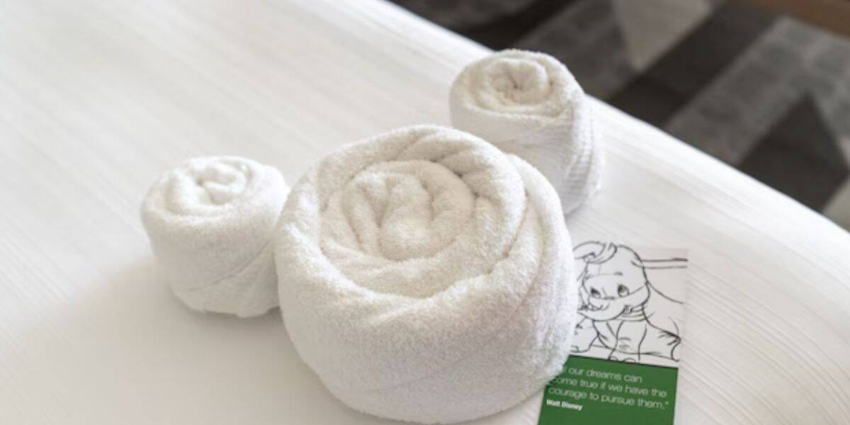 "Mousekeeping" crew leaves towels on hotel bed in the shape of Mickey Mouse
