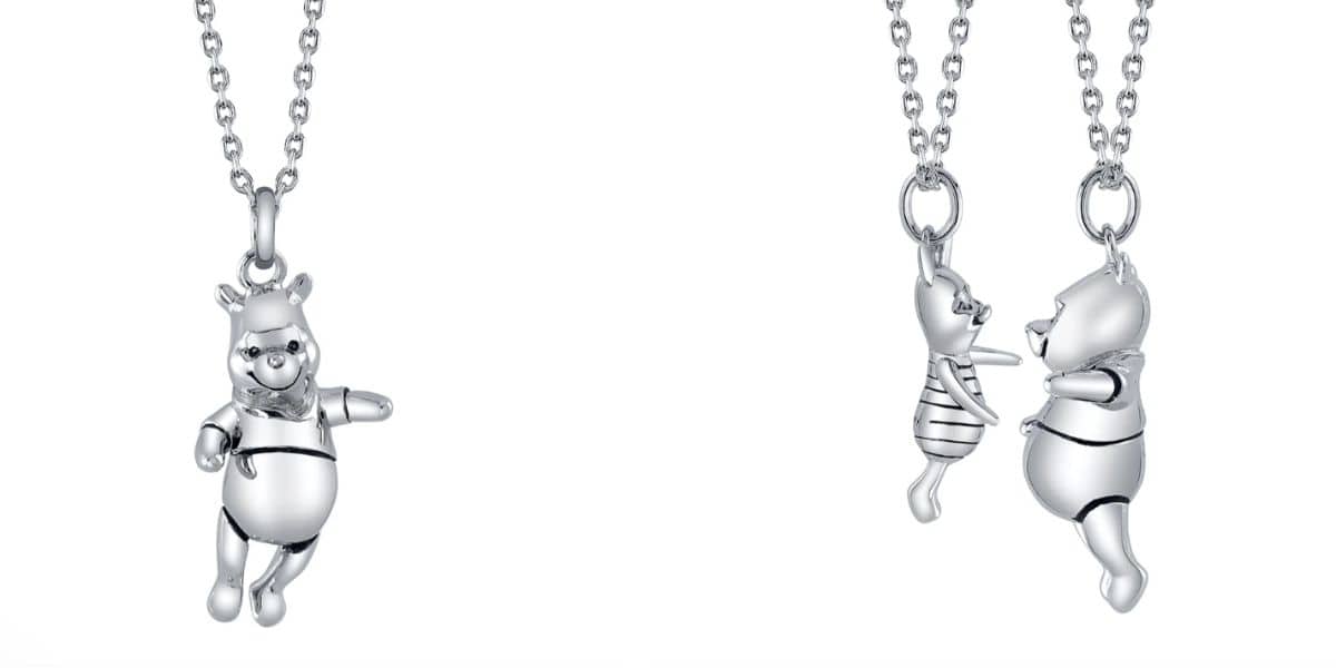 A Pooh necklace, shown interacting with a Piglet necklace.