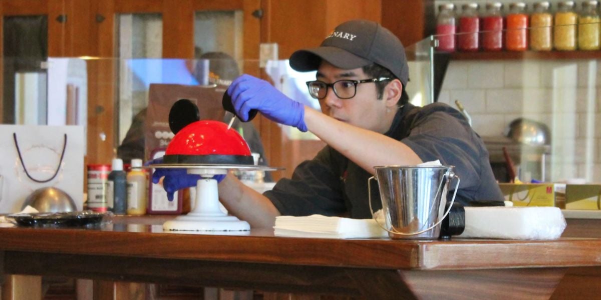 An instructor during a cake decorating class at Amorette's Patisserie