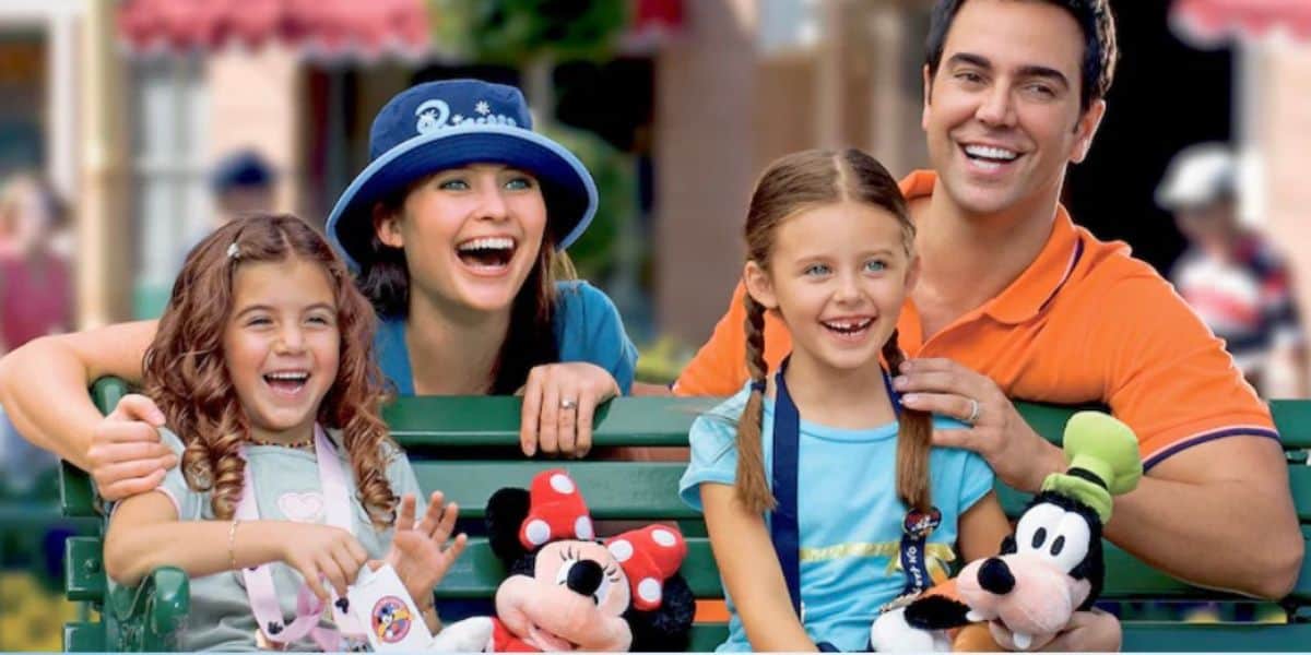 a Disney World family inside the parks with Minnie and Goofy stuffed animals