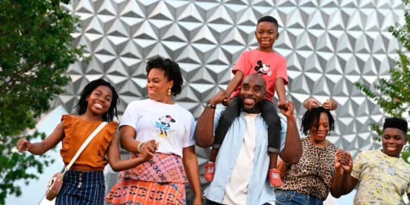 family in front of spaceship earth in disney world's epcot park