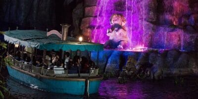 Guests pass by a baby elephant at night on Jungle Cruise: Wildlife Expeditions