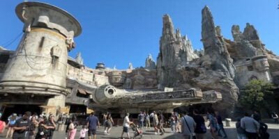 Guests walking past the Millennium Falcon in Star Wars: Galaxy's Edge