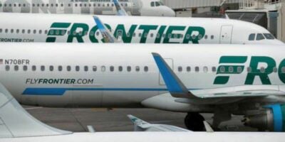 Frontier Airlines jets, decked in vibrant green and blue, await guests at the gate like thrilling rides ready to launch. Frontier Airlines Denver incident.