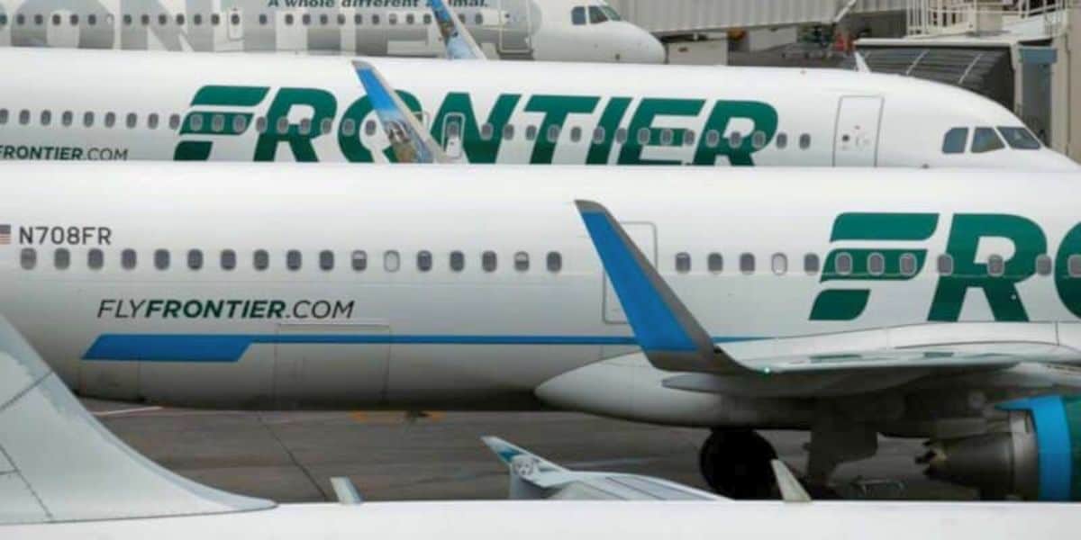 Frontier Airlines jets, decked in vibrant green and blue, await guests at the gate like thrilling rides ready to launch. Frontier Airlines Denver incident.