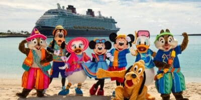 Mickey Mouse and friends in front of a Disney Cruise Line ship