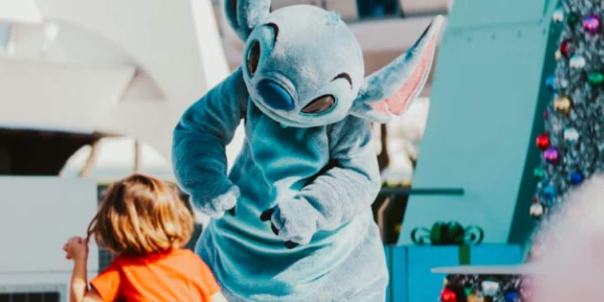 Disney's stitch mascot interacts with a young guest at disney world