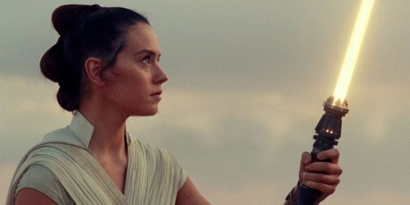 Rey Skywalker (Daisy Ridley) holding yellow lightsaber at the end of 'Star Wars: The Rise of Skywalker'