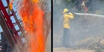 A Six Flags firefighter battles flames near a blazing roller coaster as the park endures a dramatic fire emergency. Six Flags Magic Mountain fire