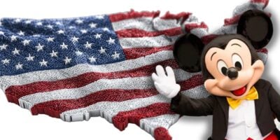 Mickey Mouse greets Disney guests before a USA map with flag colors, spotlighting State Department travel restrictions for visitors.