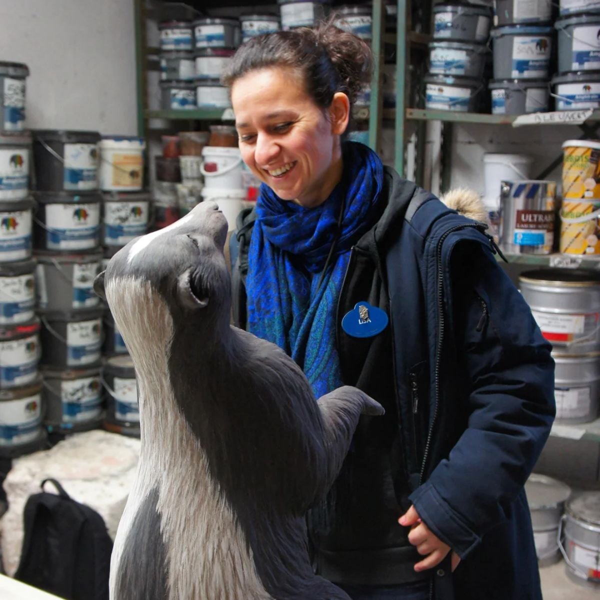 An imagineer working on a skunk figure for the Rivers of the Far West