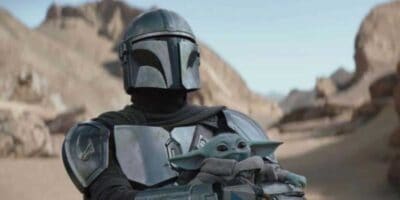 The Mandalorian Din Djarin holding Grogu