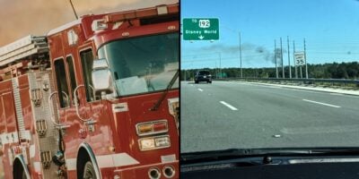 Eye-catching close-up of a fire truck on the left, while on the right, cars cruise down the highway approaching the iconic Disney World entrance under a bright blue sky. Disney World resort fire.