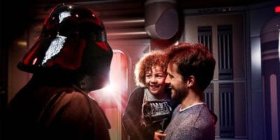 A child meets Darth Vader with their father at Starport