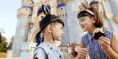 Two children in front of Cinderella Castle