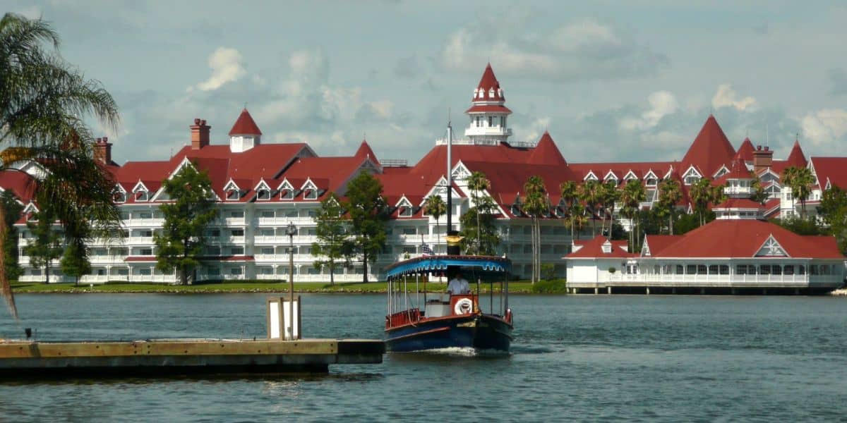 A boat on the Seven Seas Lagoon in front of Disney's Grand Floridian Resort & Spa