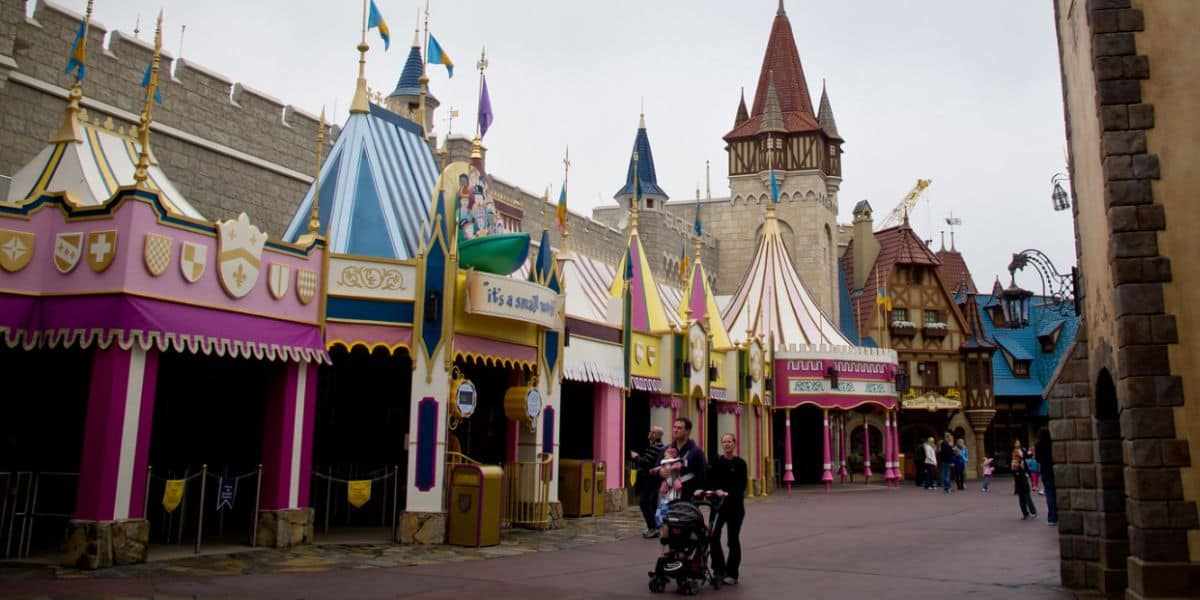 A few guests walk by "It's a small world" in Fantasyland at the Magic Kingdom
