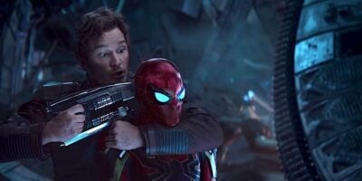 Peter Quill holding a gun to Spider-Man's head