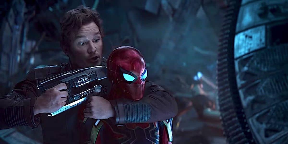 Peter Quill holding a gun to Spider-Man's head