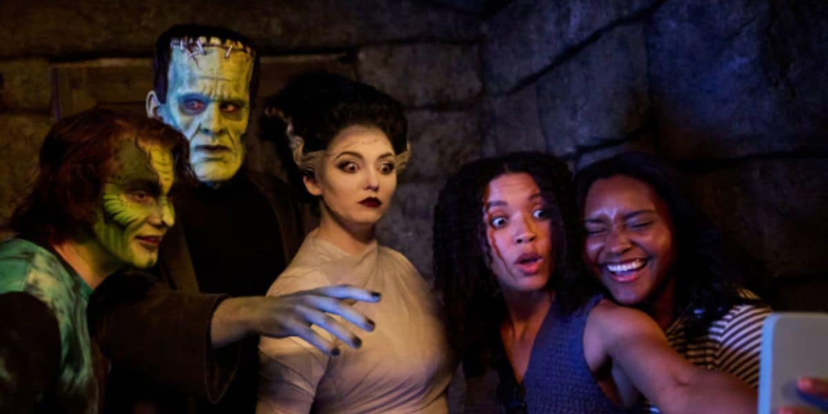 epic universe universal guests take a selfie with frankenstein and his bride in dark universe