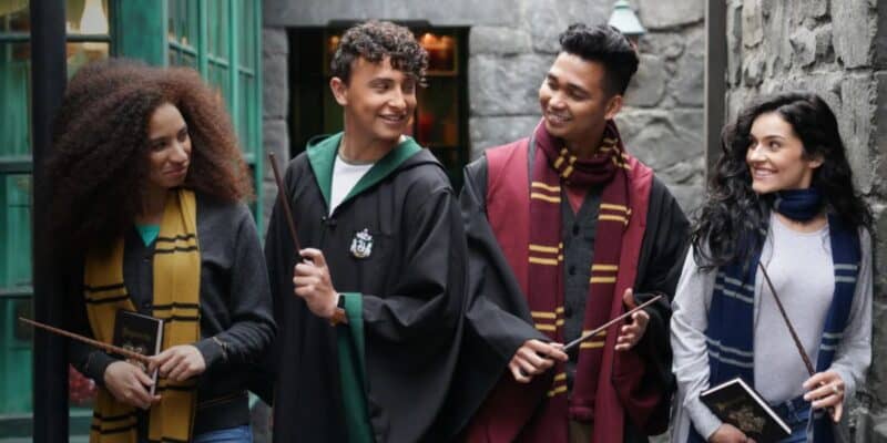 Harry Potter fans in robes with wands in Universal's Diagon Alley