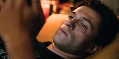 Tom Holland as Peter Parker looking sad and on his phone in 'Spider-Man: Brand New Day'