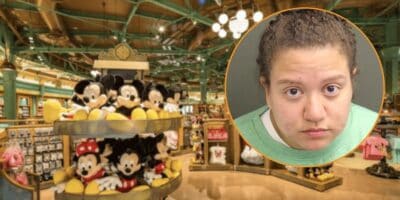 A mugshot of the former Disney cast member who stole over $2000 in merchandise, edited in front of a photo of a shopping area inside World of Disney.