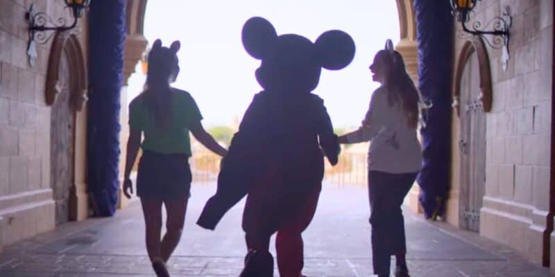 Disney World guests walk with Mickey Mouse in Magic Kingdom, despite Disney World prices climbing and not showing any sign of stopping.