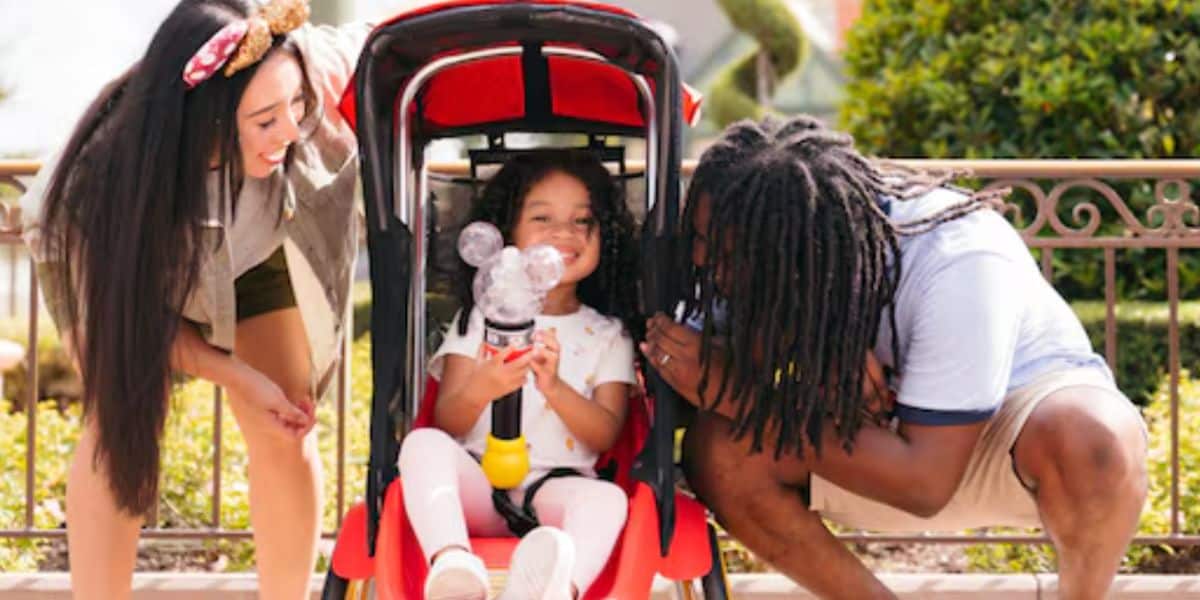 young child sits in disney world stroller
