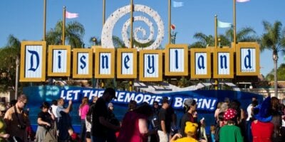 A "Let the memories begin sign" in the esplanade near the entrance to Disneyland Park and Disney California Adventure Park
