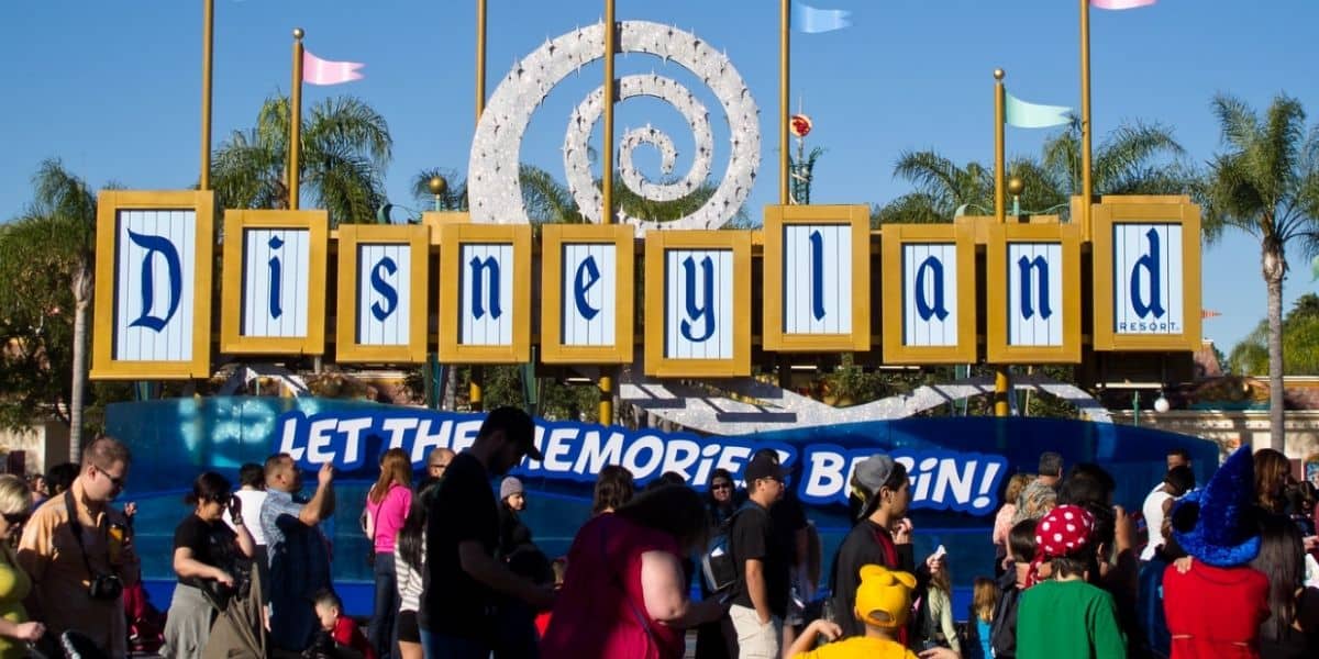 A "Let the memories begin sign" in the esplanade near the entrance to Disneyland Park and Disney California Adventure Park
