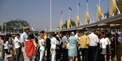 An archival photo of guests at the entrance to Disneyland Park.