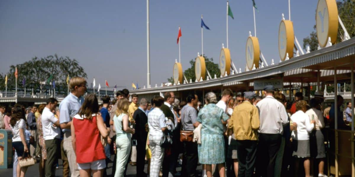 An archival photo of guests at the entrance to Disneyland Park.