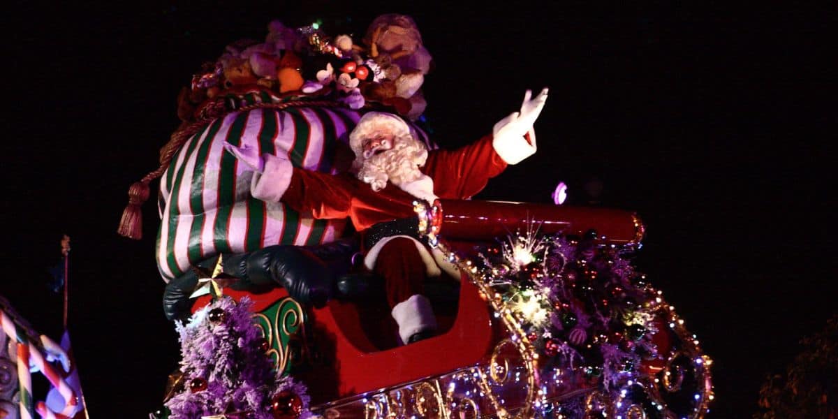 Santa Claus on a parade float styled as a sleigh at Disneyland Resort