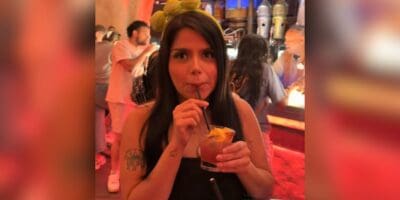A guest sipping a drink at Oga's Cantina.