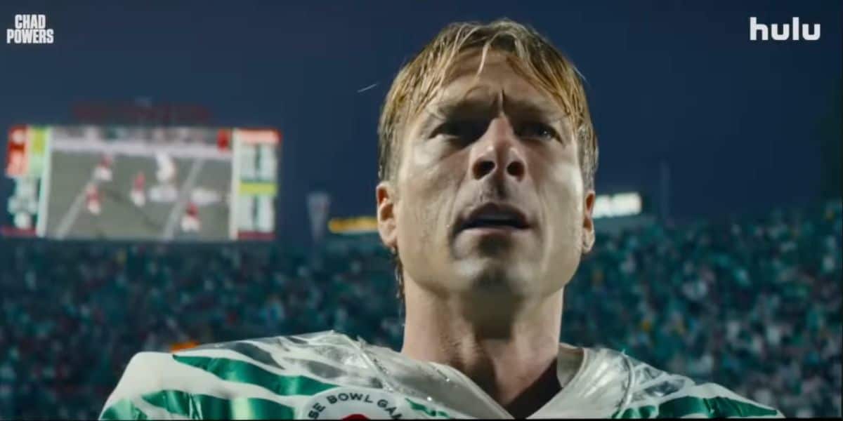 Chad Powers, suited up in his football uniform, stands proudly on the field under stadium lights with the vibrant crowd and scoreboard glowing behind him, capturing the excitement and energy you’d expect from Hulu’s hit Disney series.