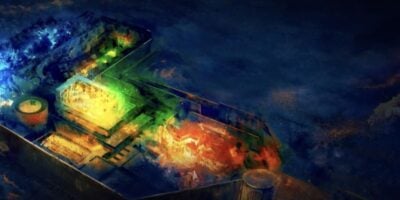 An aerial, abstract view of a ship at sea radiates with vibrant blue, green, orange, and red lights—channeling the magical excitement and immersive energy of a new Harry Potter ride at Universal’s Wizarding World.