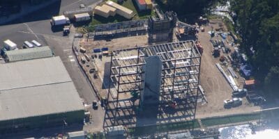 Aerial view of an exciting new construction site at Walt Disney World, showcasing a steel building frame and scattered equipment—sparking speculation about what magical attraction might be coming next to the Magic Kingdom.