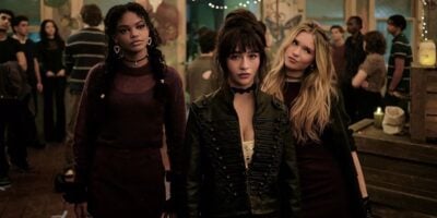 Three friends pose together in a moody lounge area during a lively after-hours event at Universal Studios, giving the camera their best serious expressions.