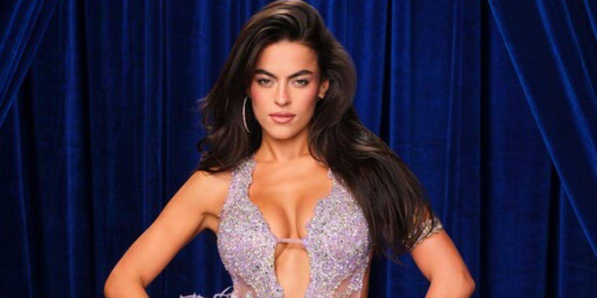 Shimmering in a dazzling, show-stopping gown, the performer strikes a glamorous pose before a lush blue velvet backdrop, evoking the star quality and excitement you’d find on center stage at Disney’s Hollywood Studios.