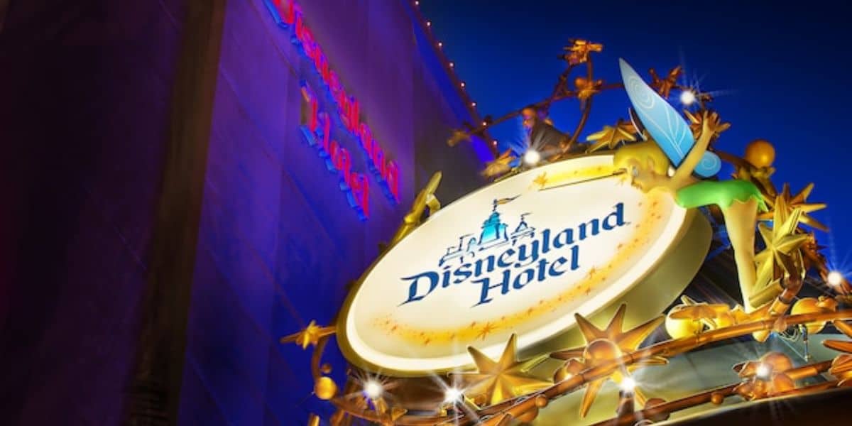 The Disneyland Hotel sign, topped with a sparkling Tinker Bell, at night