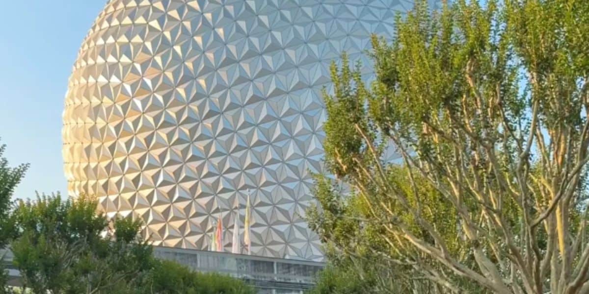 Spaceship Earth hidden behind trees inside Disney World's EPCOT theme park