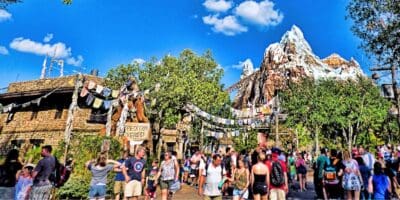 Guests walking through Asia at Disney's Animal Kingdom Theme Park with Expedition Everest in the background.